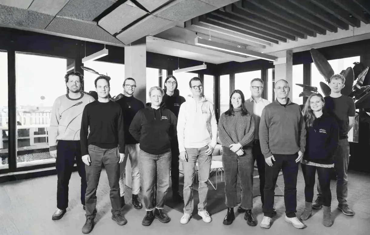 Black-and-white group photo of the Effektiv Spenden team in their office