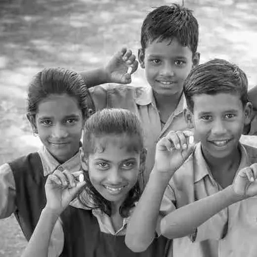 Deworm the World Initiative - Children with deworming tablets