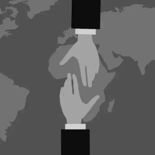 Illustration: a hand reaches out over a world map toward another hand