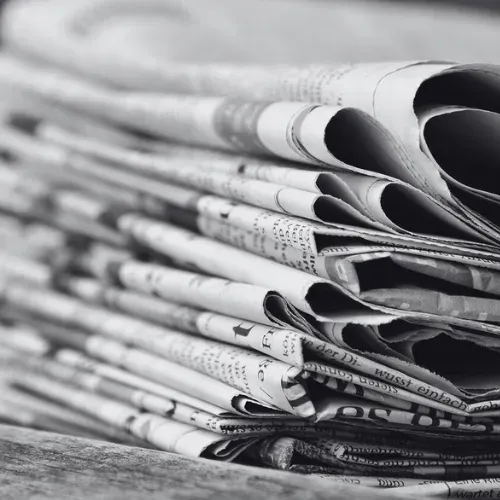 A stack of folded newspapers